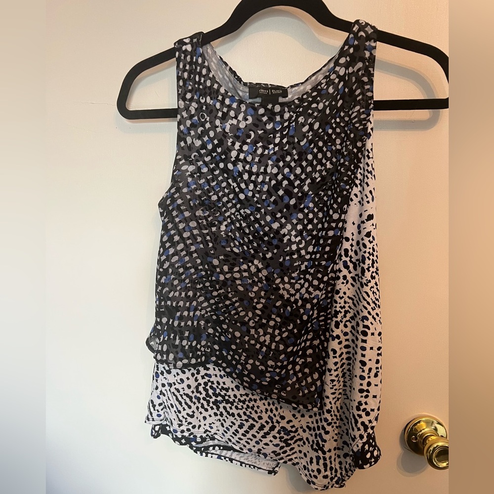 Sleeveless blouse. Front flowy fabric, back stretchy knit.